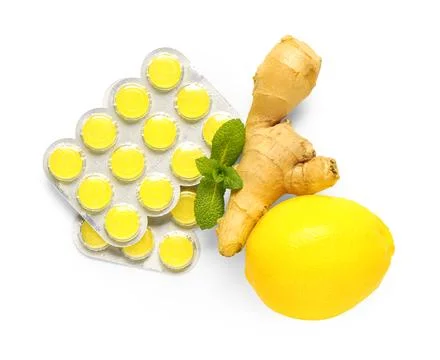 Throat lozenges with lemon, ginger root and mint leaves isolated on white bac Stock Photos