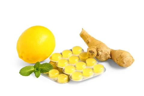 Throat lozenges with lemon, ginger root and mint leaves isolated on white bac Stock Photos