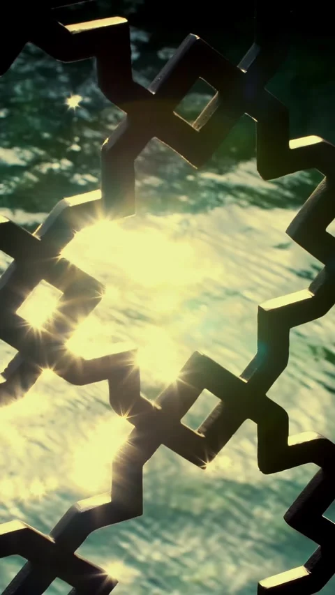 Through a beautiful openwork lattice, you can see sunbeams on the water. Stock Footage 319294886