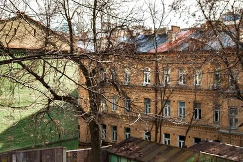 Through the branches of the trees of the old city of Kiev can see the roof Stock Photos