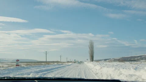 Through car window snow-covered road Snow-covered road demands cautious driving Stock Footage 265480579