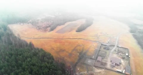 Through the clouds to a lonely farm with a quadcopter Stock Footage 169479316