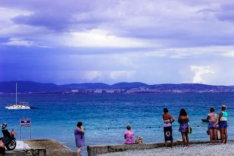Through the clouds over the sea a ray of sunshine makes its way Stock Photos