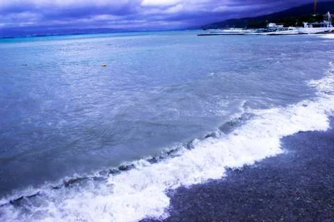 Through the clouds over the sea a ray of sunshine makes its way Stock Photos