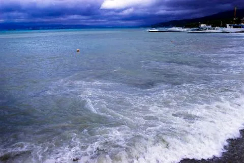 Through the clouds over the sea a ray of sunshine makes its way Stock Photos