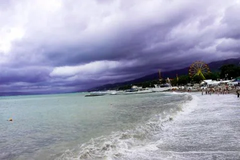 Through the clouds over the sea a ray of sunshine makes its way Stock Photos