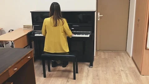 Through dedicated practice, a pianist refines her technique and musical Stock Footage 305651298