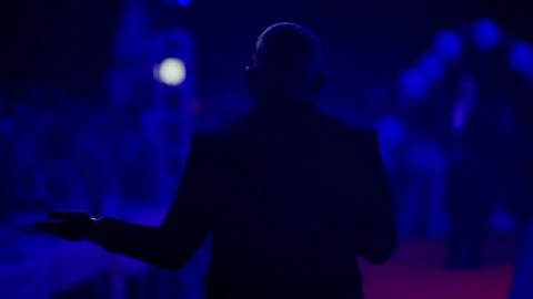 Through the focused lens of a camera, the stage is seen in a blur, suggesting Stock Footage 260060343