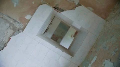Through the hole in the wall of abandoned building, rotated point of view Stock Footage 112743428