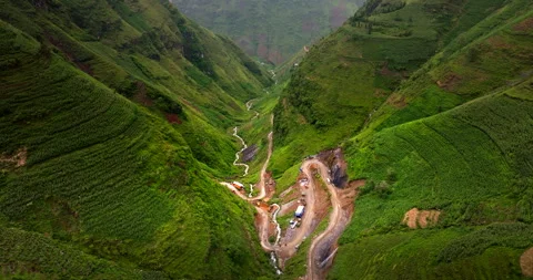 Through the loop of the valley and mountains, like emerald green fountain Stock Footage 282771122