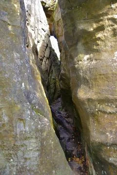 A through narrow gap is an arch between quartz sandstone megaliths in the Kam Stock Photos