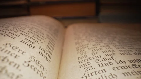 Through pages of old german Bible book. Tradition, wisdom, macro Letters symbols Stock Footage 302271132
