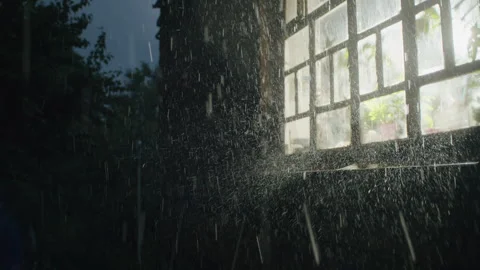 Through the rain-streaked window, the night takes on an abstract beauty, with Stock Footage 249648596