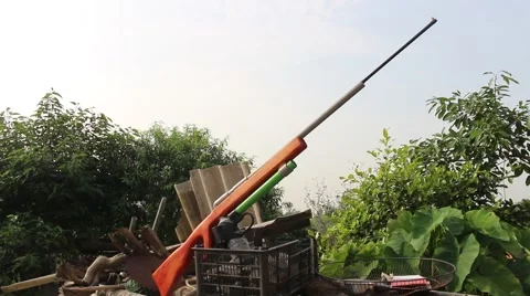 Through shoulder view of a man shooting a gun, sporting gun Stock Footage 49699456