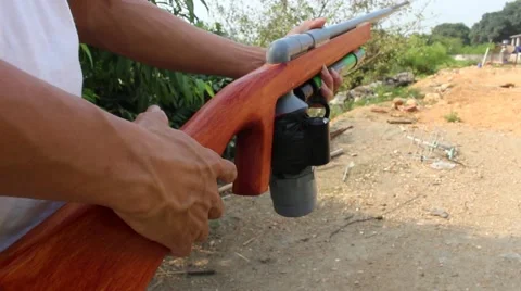 Through shoulder view of a man shooting a gun, sporting gun Stock Footage 49699552
