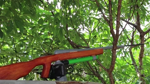 Through shoulder view of a man shooting a gun, sporting gun Stock Footage 49699740