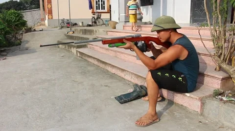 Through shoulder view of a man shooting a gun, sporting gun Stock Footage 49699875