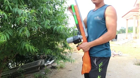 Through shoulder view of a man shooting a gun, sporting gun Stock Footage 49713629