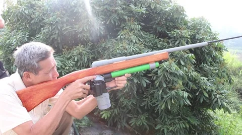Through shoulder view of a man shooting a gun, sporting gun Stock Footage 49713750