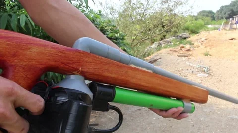 Through shoulder view of a man shooting a gun, sporting gun Stock Footage 49715440