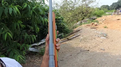Through shoulder view of a man shooting a gun, sporting gun Stock Footage 49715468