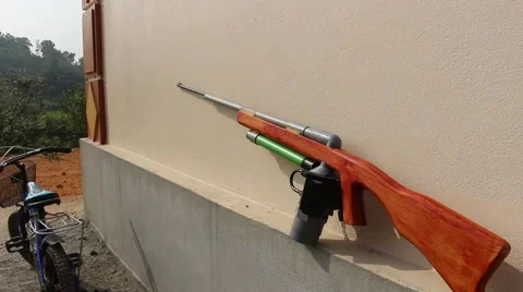 Through shoulder view of a man shooting a gun, sporting gun Stock Footage 49715523