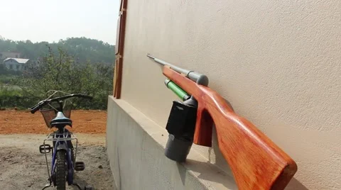 Through shoulder view of a man shooting a gun, sporting gun Stock Footage 49715622