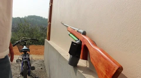 Through shoulder view of a man shooting a gun, sporting gun Stock Footage 49715628