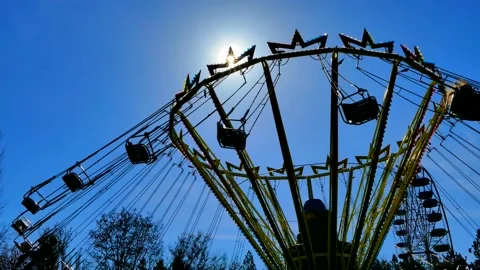 Through a spinning roundabout the sun's rays break through Stock Footage 106248260