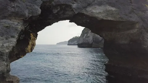 Through the stone arch towards the cliff aerial footage of Indonesia Video stock 101984134