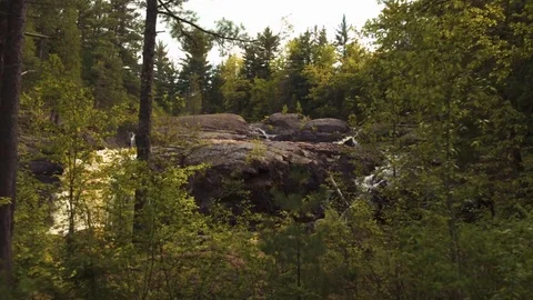 Through Trees Low Over Dead River Falls Stock Footage 71328571