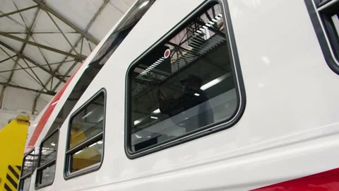 Through the window glass of the car, the work of an electrician is visible, they Stock Footage 196358180