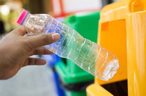 Throw away plastic bottles in the trash. 스톡 사진