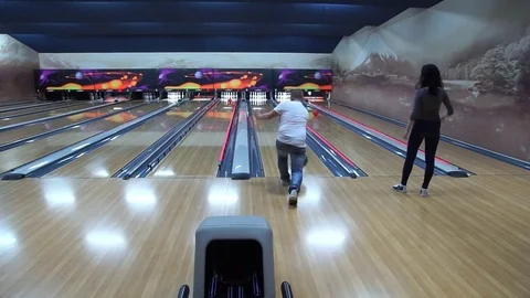 Throw the ball at some pins at the bowling alley. Stock Footage 75482104