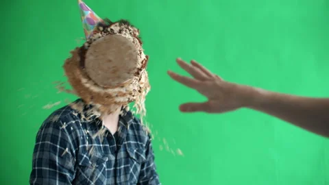 Throw birthday cake at mans face, he smiles and laughs in slow motion Video stock 118331344