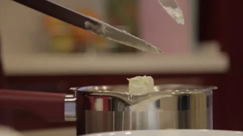 Throw butter in a saucepan Stock Footage 48813524