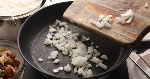 Throw the chopped onion into the pan. Stock Footage 249525981