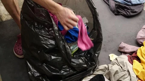 Throw clothes in the landfill. The problem of fast fashion and textile waste Stock Footage 296135660