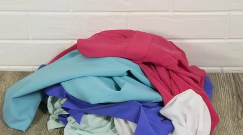 Throw clothes in a pile. A basic wardrobe. Minimalism. Clean up the closet. S 스톡 사진