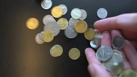 Throw coins on black surface in slow motion Stock Footage 147476011