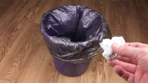 Throw the crumpled piece of paper into the trash bin.Waste disposal Stock Footage 253225076