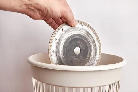 Throw the cutting disc into the trash. Waste disposal and recycling Stock Photos