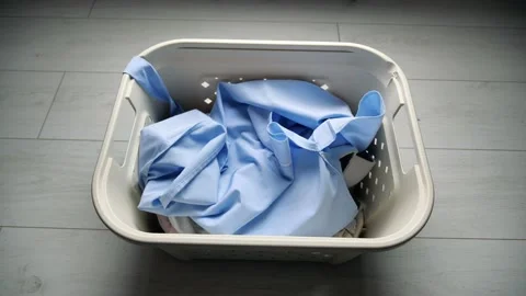 Throw dirty white shirts in the laundry basket Stock Footage 130711016