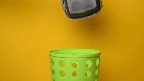 Throw the eps container into the green trash can for disposal and recycling Stock Footage 194566383