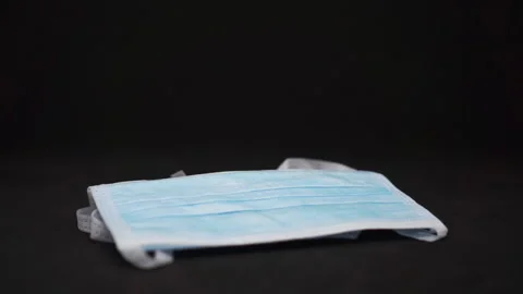 Throw Face Mask on Dark Background 库存影片 141067941
