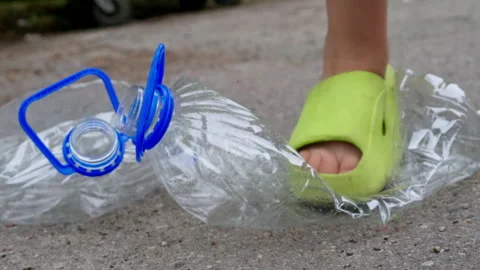 Throw garbage into a trash container. Plastic waste and water packaging. Stock Footage 270937115
