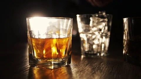 Throw ice cube into whiskey Stock Footage 119985013