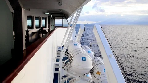 Throw overboard Davit launched self inflating boat liferaft onboard ship Stock Footage 112318167