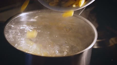 Throw the pasta into a pan of salted boiling water. Traditional Italian food . Stock Footage 143248010