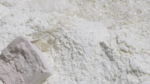 Throw a piece of yeast into the dough. slow motion Видео 100739670